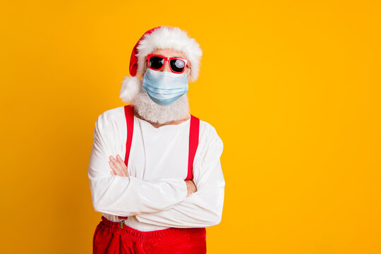 2021 celebration Funny funky santa hipster red hat fold arms festive noel party wearing gauze safety mask infection prevention mers cov isolated bright vivid shine vibrant yellow color background