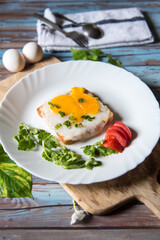 Fried eggs with toast, tomatoes and condiments with use of selective focus