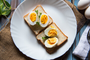 Close  up of boiled eggs on bread slice with a view from top