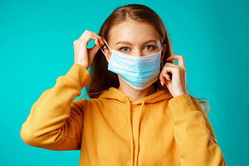 Young beautiful casual woman wearing protective medical mask