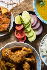 Fresh chicken and vegetable salad along with other food ingredients partly seen on a background
