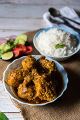 Close up of fried chicken wings with rice with salad prepared Indian style