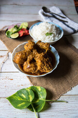 Indian style fried chicken curry with rice, a popular meal.