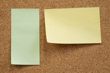 Fototapeta premium Light green and Yellow sticky note on cork board. empty free space.