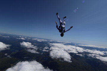 Skydivers over snowy mountains in Norway
