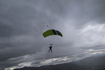 Skydivers over snowy mountains in Norway