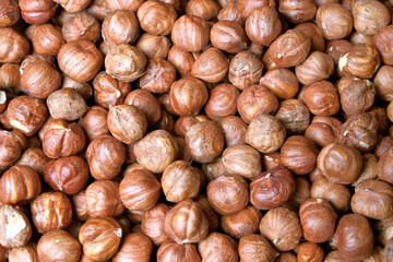 Peeled hazelnuts as a very effective and beautiful background of natural products.