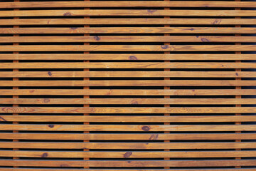 Wooden brown bars. Oak slats on wall, decorative border. Texture of the light wood boards lie horizontally. Wood background