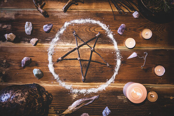 Ingredients and materials for an occultly ritual with an pentagram or pentacle, flatlay