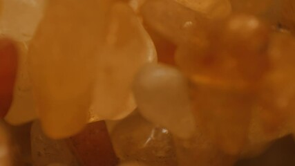 Sparkling amber stone macro shoot. 4k Resolution (3840×2160) footage of shallow depth of field. - Powered by Adobe