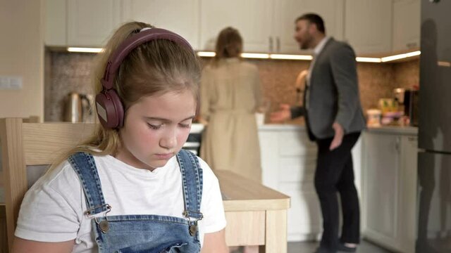 Family scandal. Parents quarrel. The child try to be distracted and not hear.