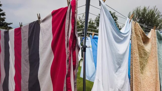 Rotary Washing Line Clothes Dryer With Laundry Clothes And Sheets Drying In The Washday Sun Video Footage Clip