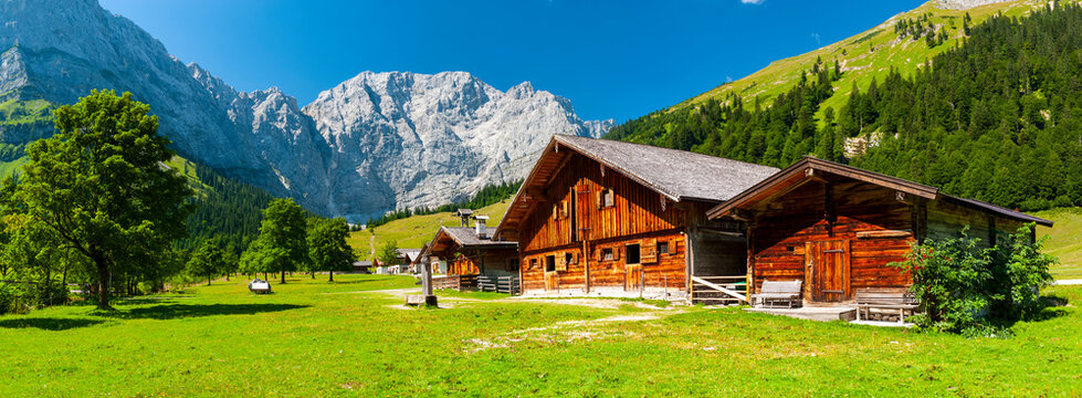 panorama landscape in alpine mountains with farmhouse