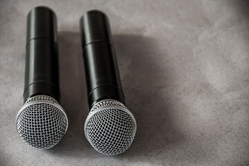  two microphones on a gray background. radio microphones in the studio. music equipment