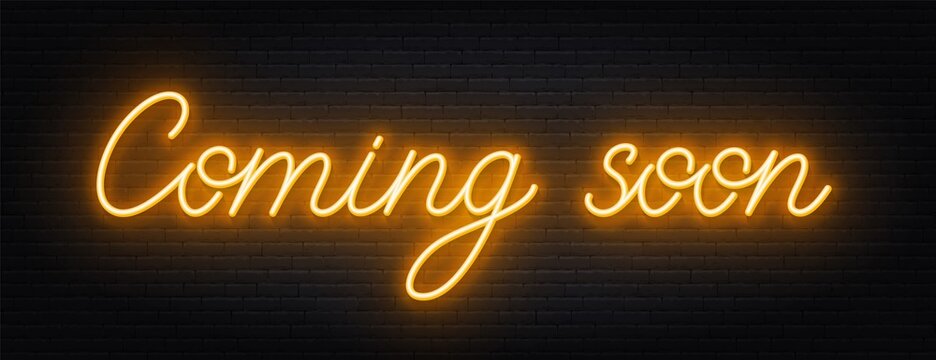 Coming soon neon script sign on brick wall background .
