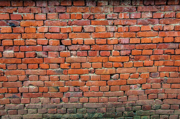 Large brick orange wall of a building.	