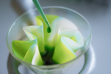 The scientist is testing the natural product extraction and green color solution, in the chemistry...