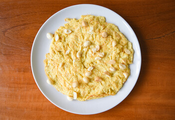 Omelette breakfast with macadamia nuts on top on white plate Healthy food
