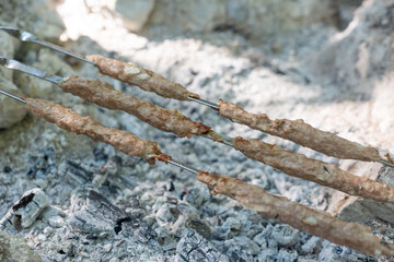 close-up, pork lula kebab on skewers, grill meat on the grill, bonfire, coals. Harmful delicious food
