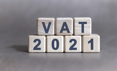 VAT text on wooden cubes on a monochrome background