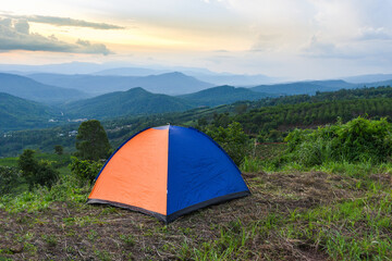 tent camping on the mountains landscape background - adventure travel camping tent in summer season