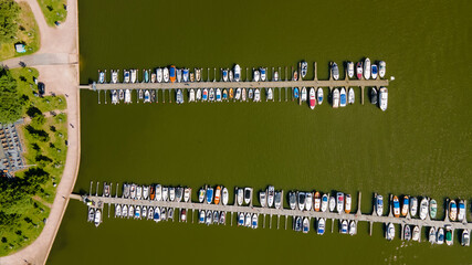 Top-Down view of Yachts, boats and kayaks docked at a port.  