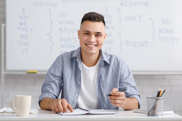 Online training concept. Man speaking looking at camera, making notes
