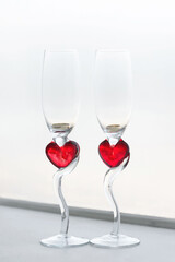 Wedding glasses with red hearts. Close up