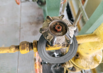 Close-up of metal valve, flywheel with nut and rubber gasket. Details, technology at the enterprise. Photography, concept.