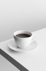 Cup of coffee on a white table.