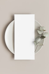 Menu card mockup with a eucalyptus branch on a plate, 4x9 ratio.