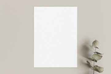 White invitation card mockup with a eucalyptus branch. 5x7 ratio, similar to A6, A5.
