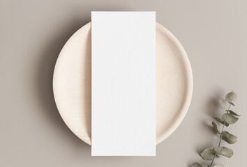 Menu card mockup with a eucalyptus branch on a plate, 4x9 ratio.