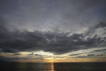 Fototapeta na wymiar Sunset. Beautiful sunset at Japanese sea. Gold cloudy sky sunset. Picture Sea sunset.