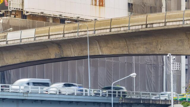 Footage 4k Timelapse, Overhead of cars moving traffic busy day, vehicles, Train passing, behind a famed view of cityscape skyline on conjunction road near the business district, Bangkok, Thailand.