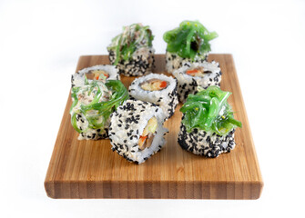 Shiitaki and chuka, beautiful rolls decorated with seaweed. Sprinkled with white and black sesame seeds.