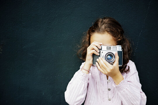 Spanish girl with brown hair and blue eye taking a photo