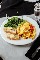 omelet with pepper and baguette, toast on a plate