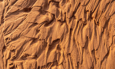 Nature closeup background of dry sand after water flows with shadows
