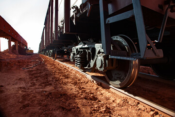 Bauxite clay open-cut mining. Loading and railway transporting terminal. Close-up of cargo train...