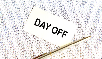 Fototapeta premium Inscription on the card DAY OFF, against the background of the report and pen.