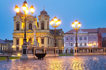 The rainy evening and night city lights on the Unirii Square of Timisoara, Romania