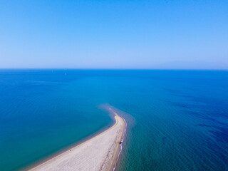 Fototapeta na wymiar Aerial view of exotic long sand beach with sea on both sides 