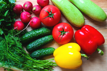Fresh vegetables background. Harvest concept. Cucumbers, radishes, tomato, green onions, zucchini, bell peppers. Healthy eating concept. Flat lay, top view. Vegetarian and organic food