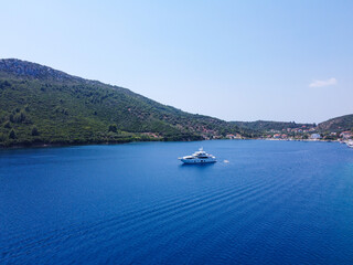 Luxury yacht sailing in blue sea surrounded with coast 