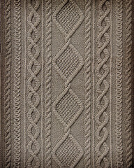 beige background texture patterned knitted fabric closeup. Embossed knitted arana pattern