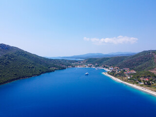 Obraz premium Luxury yacht sailing in blue sea surrounded with coast 