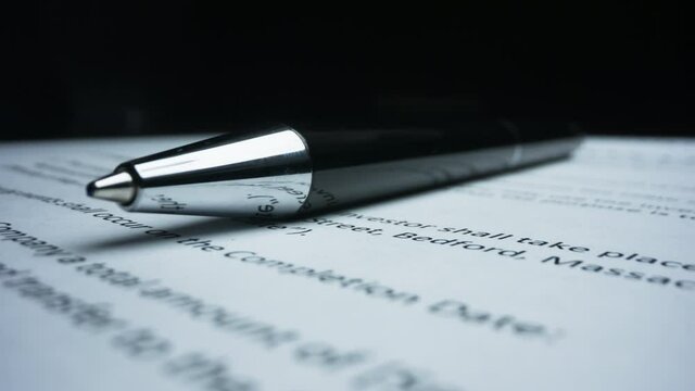 Closeup black pen lying on paper contract. Macro shot stamp with text top secret