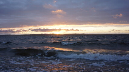 breaking waves with the setting sun