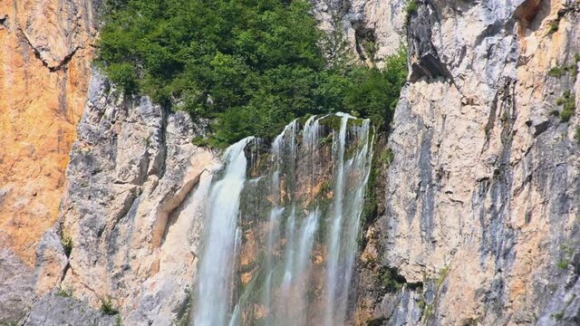 Close up edge of waterfall Boka, Slovenia. One of most beautiful waterfalls in Julian Alps. Water gently flowing down the rocks.  Static, 4K